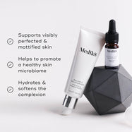 The Balance Moisturiser and and the Glycolic Acid Activator are positioned on a geometric grey object. Three bullet points with checkmarks list benefits: Supports visibly perfected & mattified skin, Helps to promote a healthy skin microbiome, and Hydrates & softens the complexion.