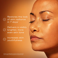 Close-up of a woman’s face with eyes closed, showing smooth, glowing skin. Text reads: ‘Restores the look of radiance & clarity. Delivers a visibly brighter, more even skin tone. Minimises the appearance of fine lines.