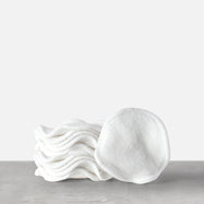 A stack of white, round reusable bamboo cotton pads